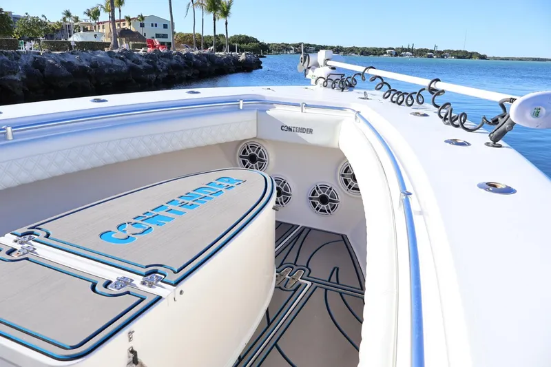  Yacht Photos Pics 2007 Contender 33 Tournament boat interior with speakers and storage, docked by a scenic shoreline.