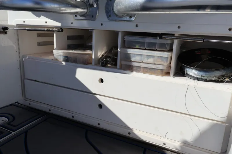  Yacht Photos Pics Storage compartments on a 2007 Contender 33 Tournament boat, featuring organized fishing gear.