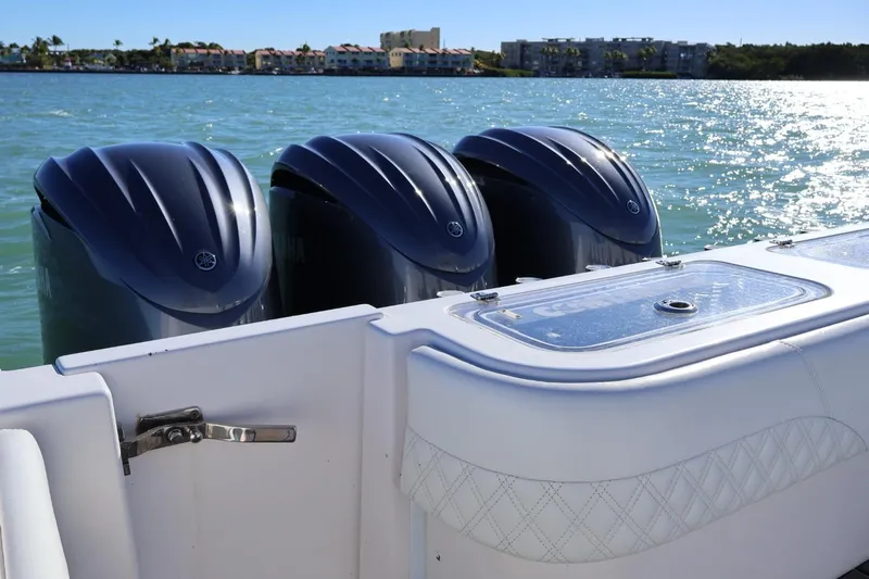  Yacht Photos Pics 2007 Contender 33 Tournament boat with triple Yamaha outboard engines on a sunny day.