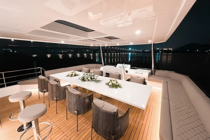  Yacht Photos Pics Luxurious 2025 GZ Yachts TY560 deck at night, featuring elegant seating and floral arrangements.