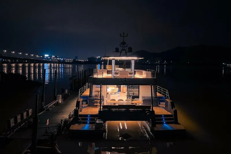  Yacht Photos Pics Luxurious 2025 GZ Yachts TY560 illuminated at night, docked by a serene waterfront.