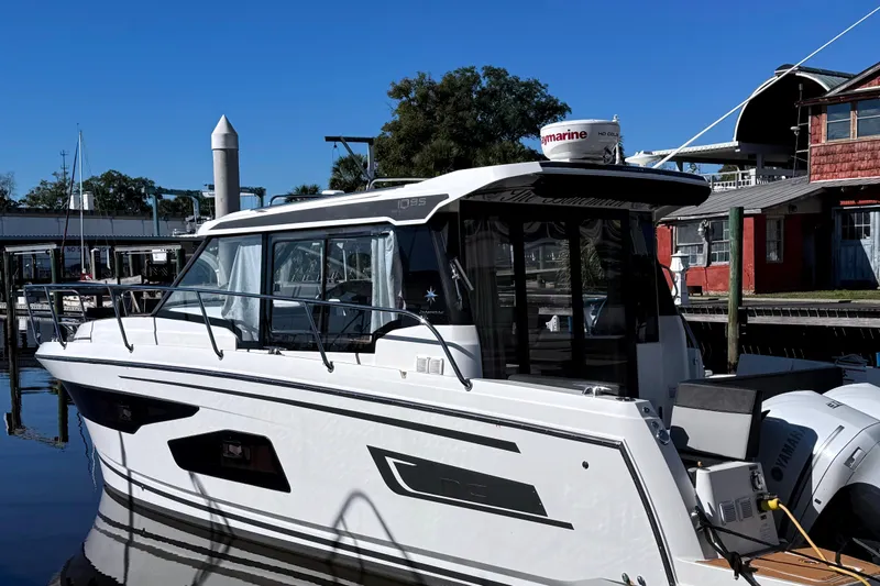 Bohemian Yacht Photos Pics 2021 Jeanneau NC Weekender 1095 boat docked at marina, side view.