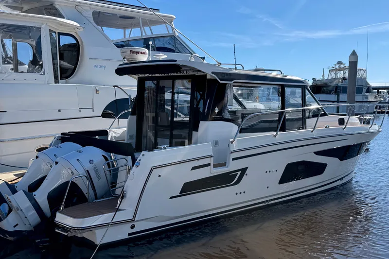 Bohemian Yacht Photos Pics 2021 Jeanneau NC Weekender 1095 boat docked with Yamaha engines, under clear blue sky.