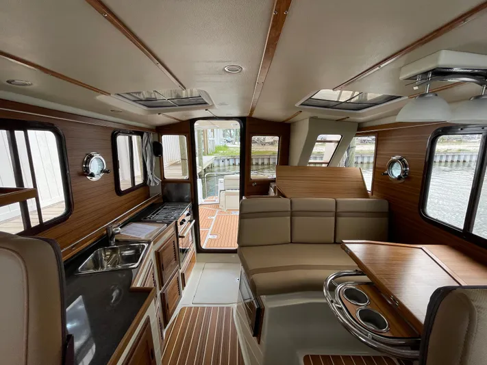  Yacht Photos Pics Interior of 2023 Ranger Tugs R-31 CB, featuring wood accents and modern amenities.