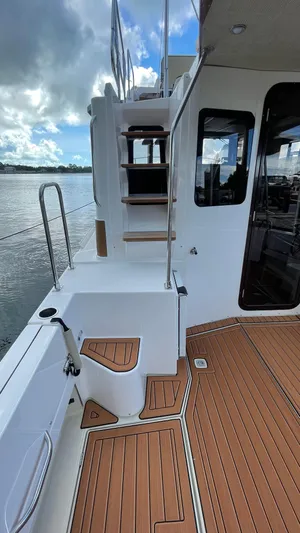  Yacht Photos Pics 2023 Ranger Tugs R-31 CB boat deck with wooden flooring and stairs.