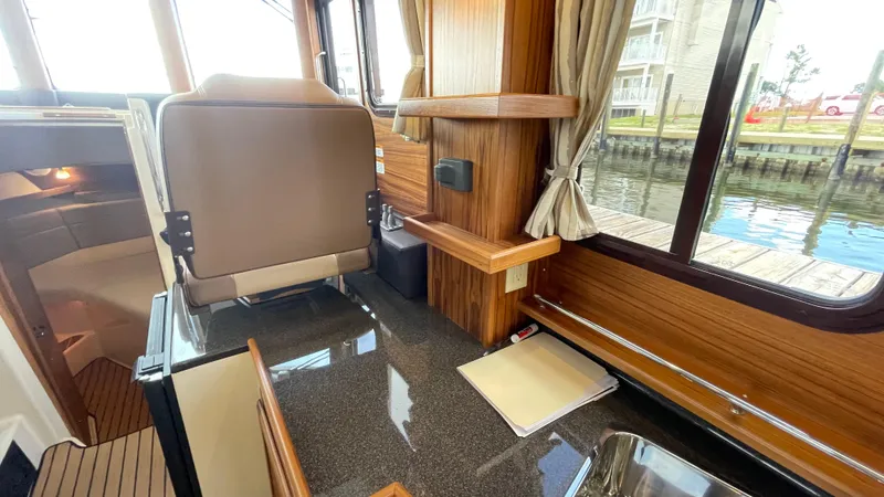  Yacht Photos Pics Interior of 2023 Ranger Tugs R-31 CB with wood accents and waterfront view.