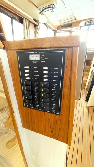  Yacht Photos Pics Control panel inside 2023 Ranger Tugs R-31 CB boat, featuring wood finish and modern design.