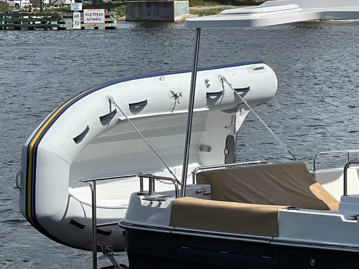  Yacht Photos Pics 2023 Ranger Tugs R-31 CB with inflatable dinghy on water.