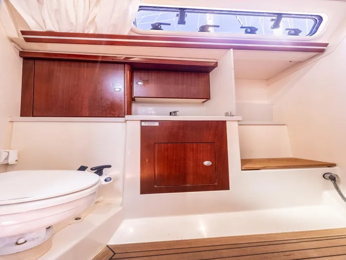  Yacht Photos Pics Interior of 2008 Hanse 400 yacht bathroom with wooden cabinets and toilet.