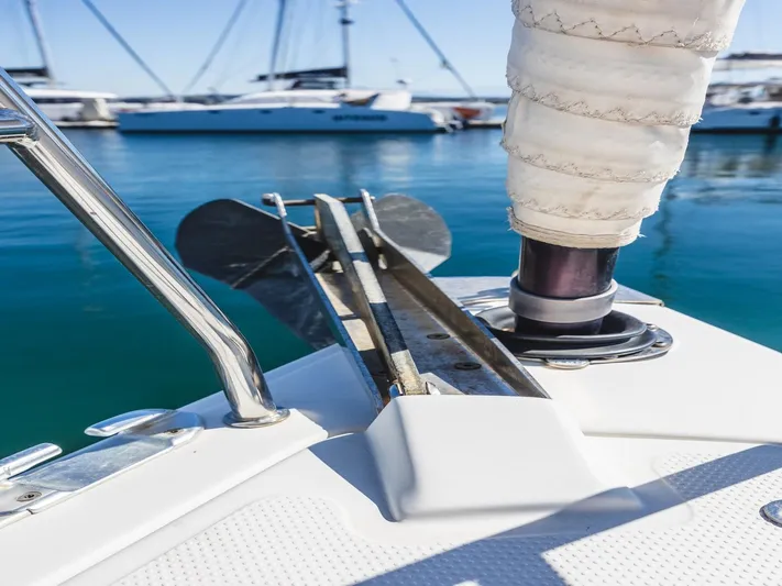  Yacht Photos Pics Bow of a 2008 Hanse 400 sailboat with anchor and marina background.