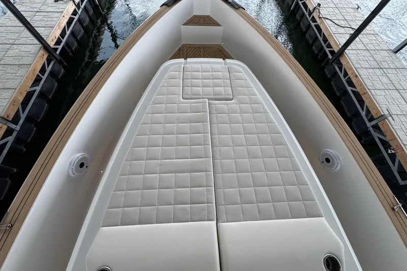  Yacht Photos Pics 2025 Pardo Yachts P38 deck with cushioned seating, docked at marina.