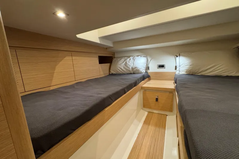  Yacht Photos Pics Luxurious cabin interior of 2025 Pardo Yachts P38 with twin beds and modern wood finish.