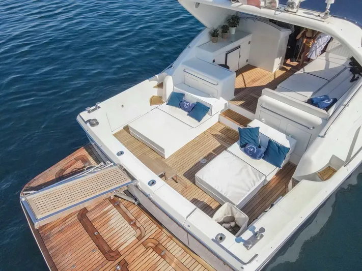  Yacht Photos Pics Luxury 1996 Uniesse 48 Open yacht with spacious deck and elegant seating.