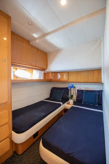  Yacht Photos Pics Interior cabin of 1996 Uniesse 48 Open yacht with twin beds and wooden accents.