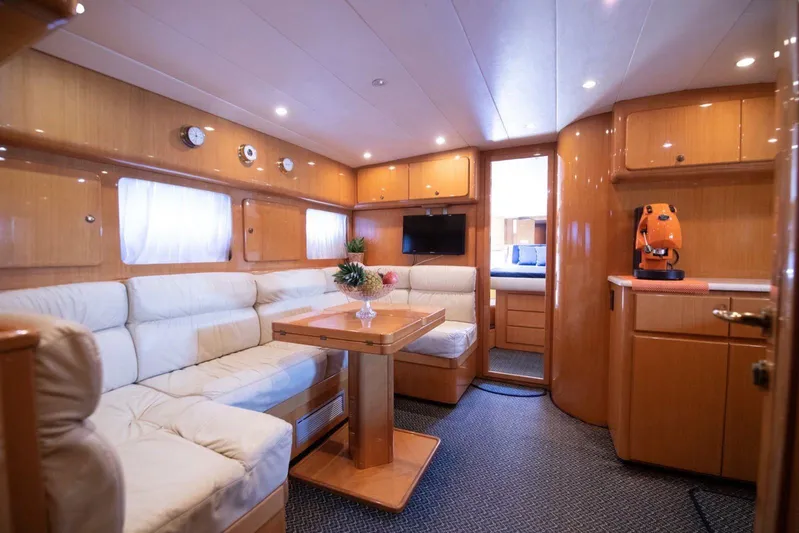 Yacht Photos Pics Luxurious interior of 1996 Uniesse 48 Open yacht with plush seating and elegant wood finishes.