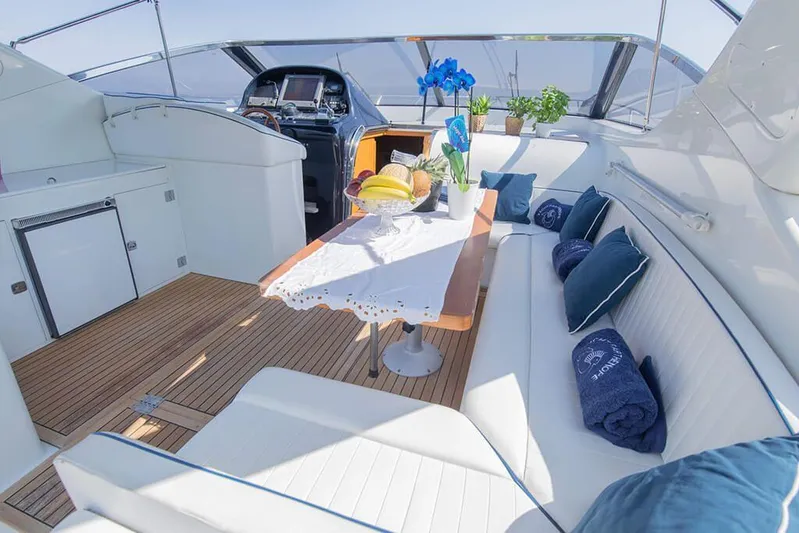  Yacht Photos Pics Luxurious 1996 Uniesse 48 Open yacht interior with elegant seating and dining area.