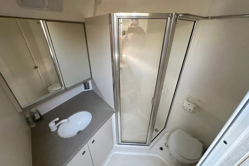 Dunac's Minni Conn III Yacht Photos Pics Bathroom interior of 1997 Silverton 422 Motor Yacht with shower, sink, and toilet.