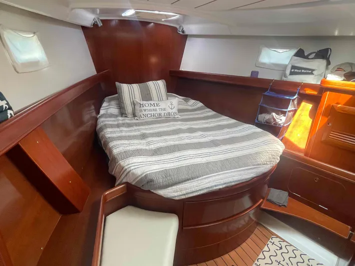 Tiramisu Yacht Photos Pics Cozy cabin interior of 2004 Beneteau Oceanis 473 sailboat with striped bedding.