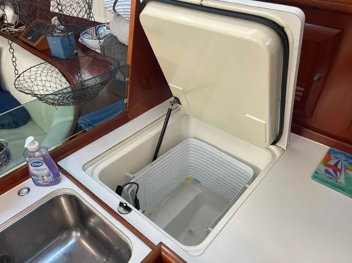 Tiramisu Yacht Photos Pics Open fridge in 2004 Beneteau Oceanis 473 yacht kitchen, with sink and countertop.