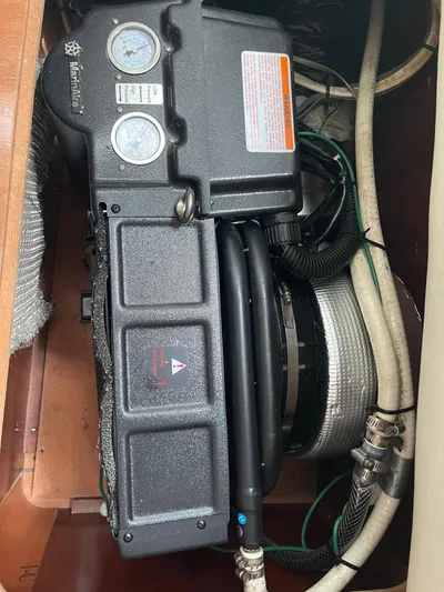 Tiramisu Yacht Photos Pics Engine compartment of a 2004 Beneteau Oceanis 473 sailboat, showing gauges and hoses.