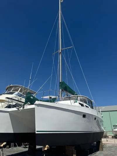 Shamrock Yacht Photos Pics 2002 Endeavour 44 Sail Catamaran docked under clear blue sky.