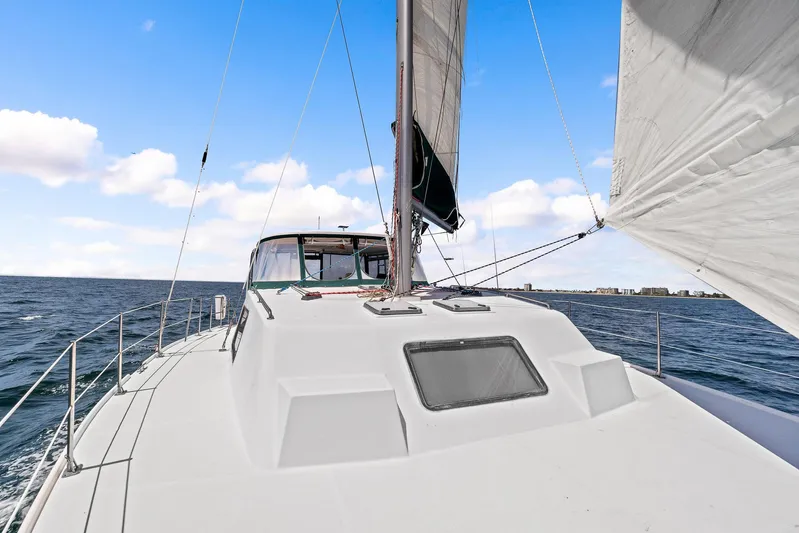 Shamrock Yacht Photos Pics 2002 Endeavour 44 Sail Catamaran sailing on open water under a clear blue sky.