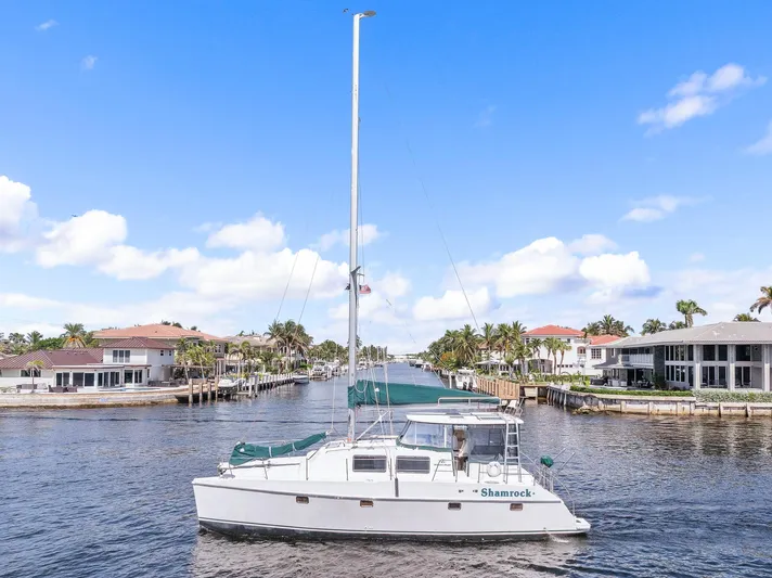 Shamrock Yacht Photos Pics 2002 Endeavour 44 Sail Catamaran on a scenic waterway with waterfront homes.
