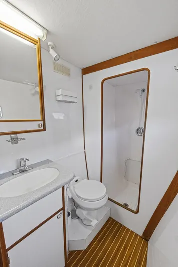 Shamrock Yacht Photos Pics 2002 Endeavour 44 Sail Catamaran bathroom with shower, sink, and toilet.