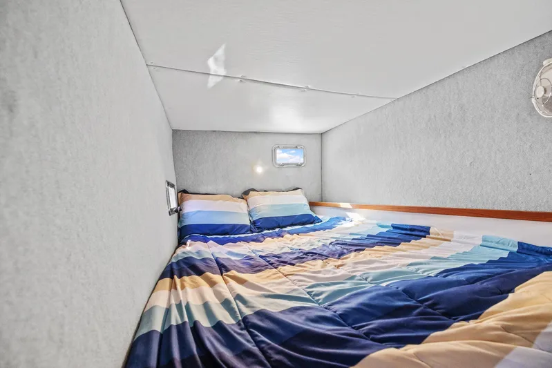 Shamrock Yacht Photos Pics Cozy bedroom in 2002 Endeavour 44 Sail Catamaran with striped bedding.