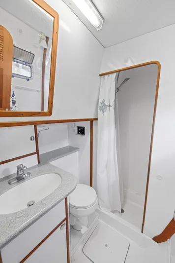 Shamrock Yacht Photos Pics 2002 Endeavour 44 Sail Catamaran bathroom with shower, sink, and toilet.