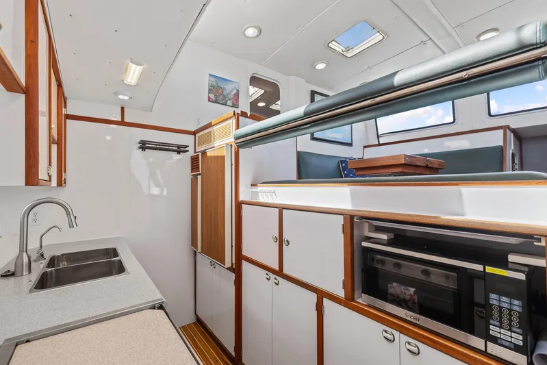 Shamrock Yacht Photos Pics Interior of 2002 Endeavour 44 Sail Catamaran with modern kitchen and ample storage.