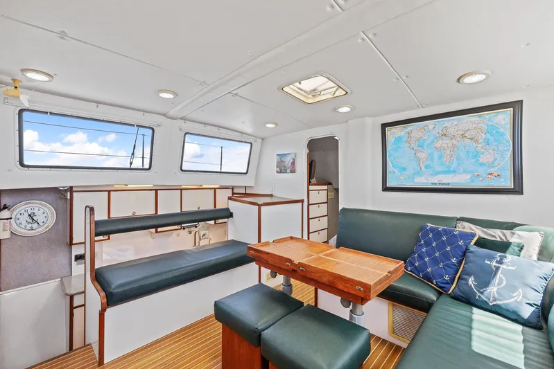 Shamrock Yacht Photos Pics Interior of 2002 Endeavour 44 Sail Catamaran with seating, table, and world map.