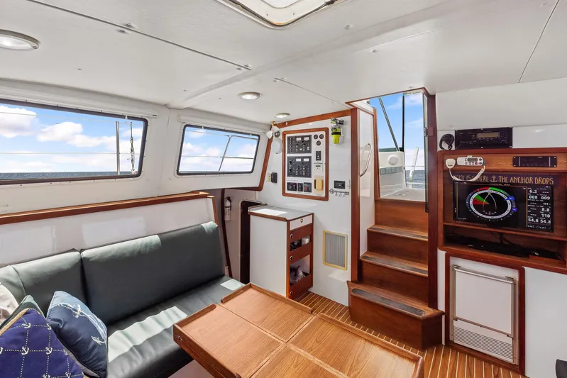 Shamrock Yacht Photos Pics Interior of 2002 Endeavour 44 Sail Catamaran with seating, control panel, and navigation equipment.