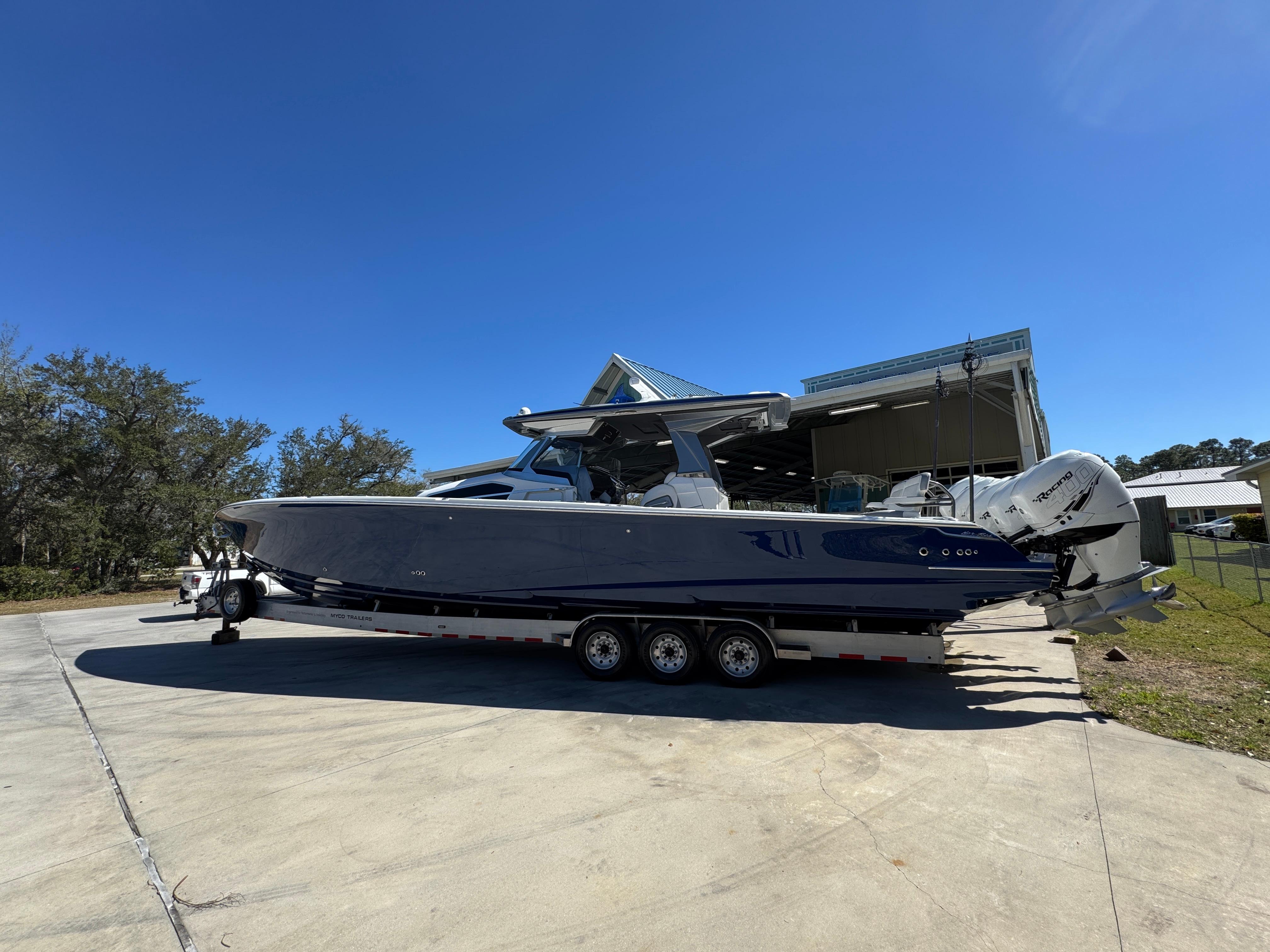 2018 Nor-Tech 452 Super Fish boat on trailer, parked outdoors under clear blue sky.