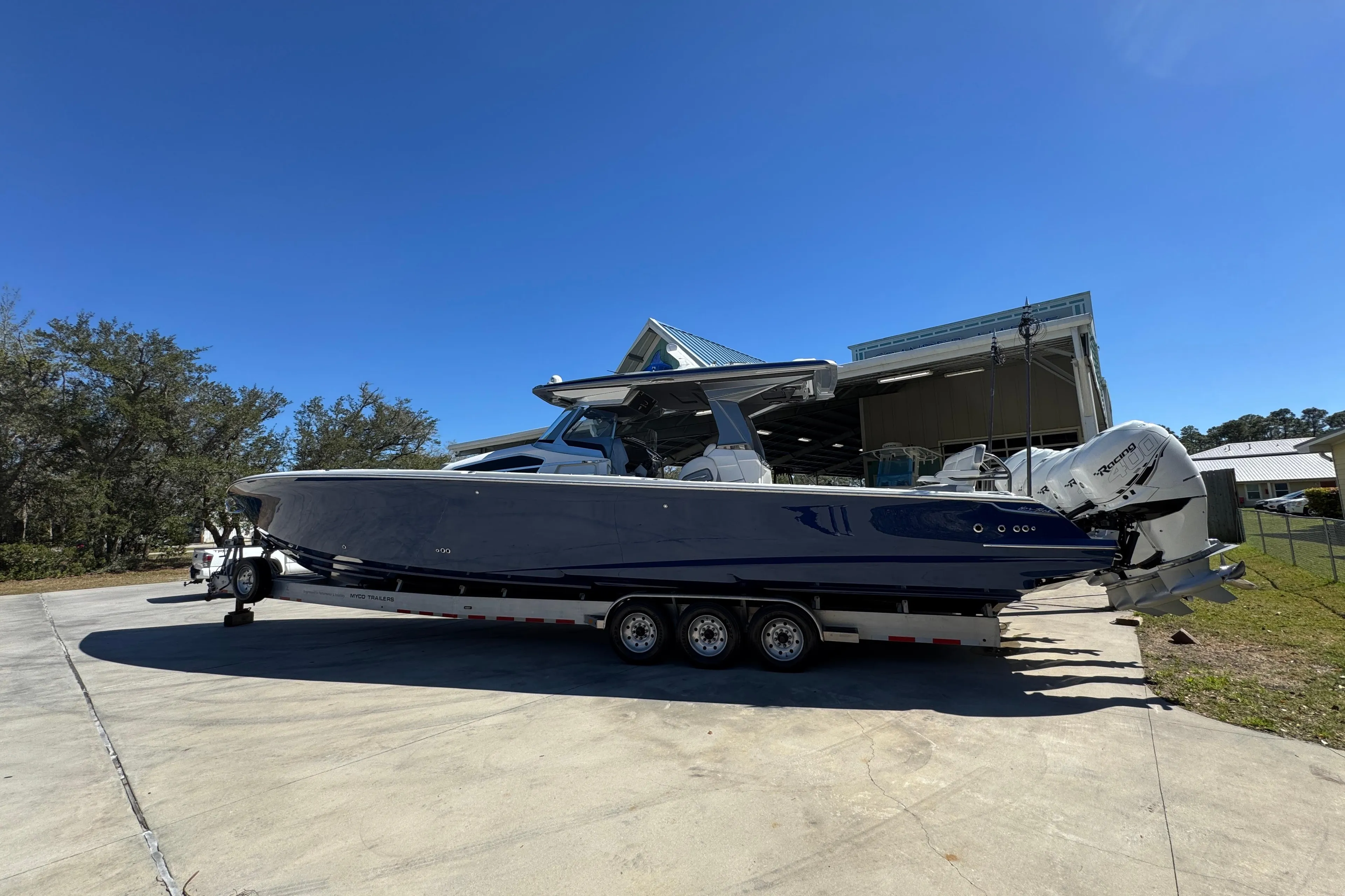 2018 Nor-Tech 452 Super Fish boat on trailer, parked outdoors under clear blue sky.