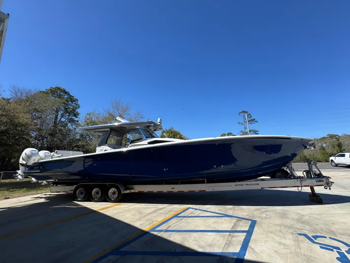  Yacht Photos Pics 2018 Nor-Tech 452 Super Fish boat on trailer, parked outdoors under clear blue sky.