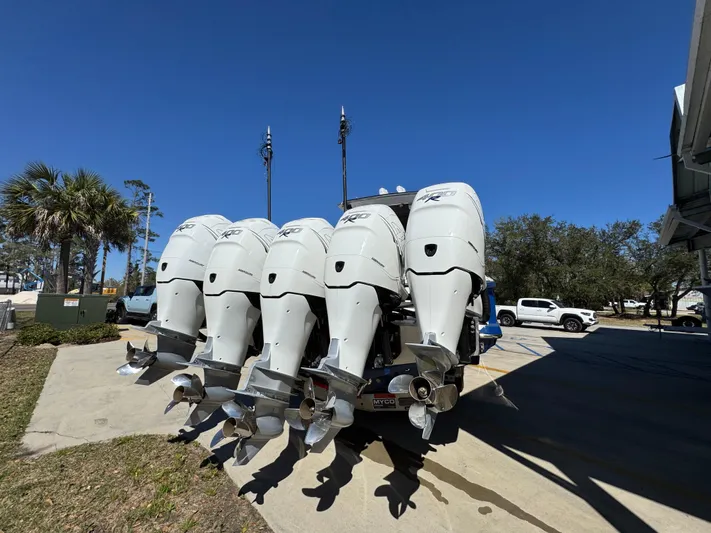  Yacht Photos Pics Five powerful outboard motors on a 2018 Nor-Tech 452 Super Fish boat, parked outdoors.