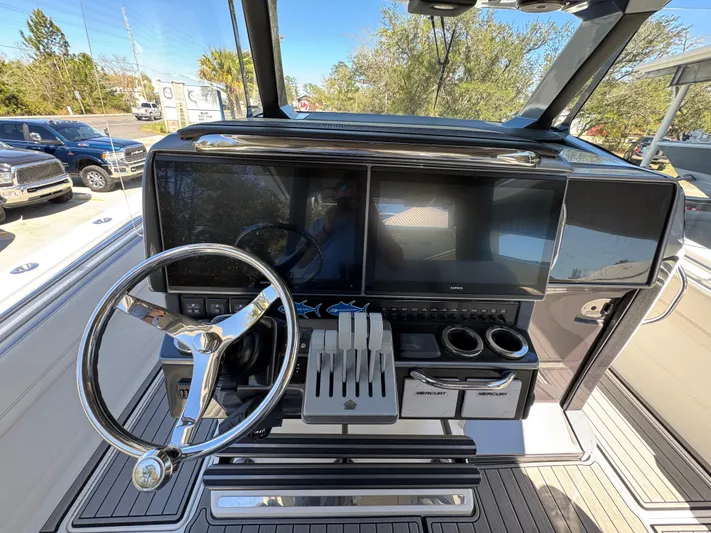  Yacht Photos Pics 2018 Nor-Tech 452 Super Fish dashboard with steering wheel and navigation screens.