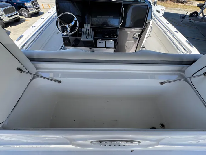  Yacht Photos Pics 2018 Nor-Tech 452 Super Fish boat interior with steering wheel and storage compartment.