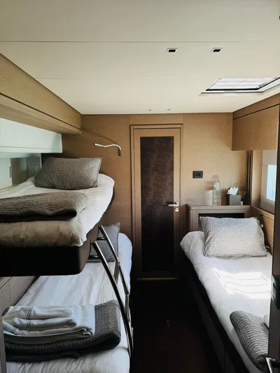  Yacht Photos Pics 2024 Lagoon 65 yacht cabin with bunk beds and modern decor.