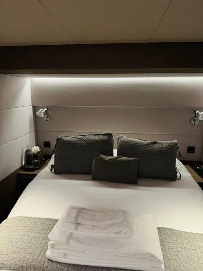  Yacht Photos Pics Luxurious bedroom interior of 2024 Lagoon 65 yacht with modern lighting and cozy bedding.