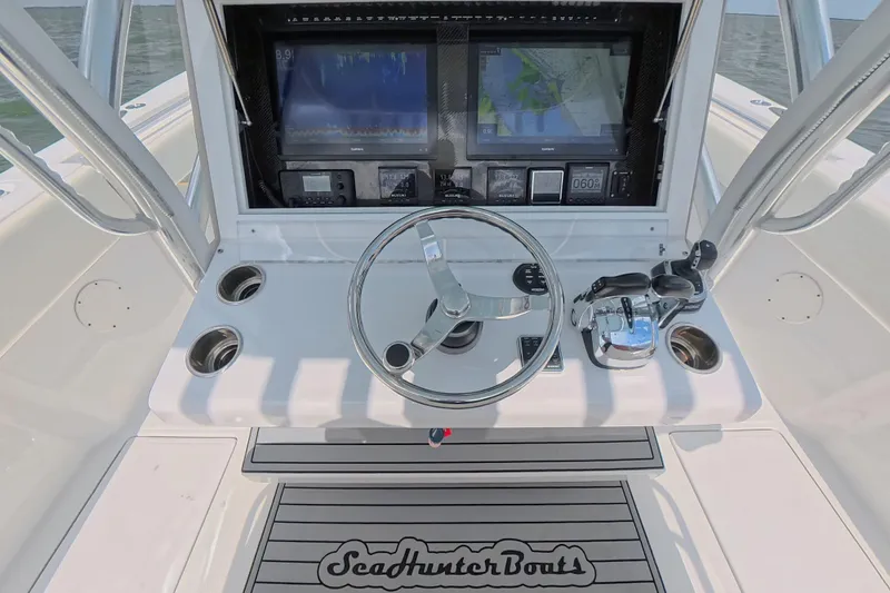  Yacht Photos Pics 2019 SeaHunter 33 Tournament boat helm with steering wheel and navigation screens.