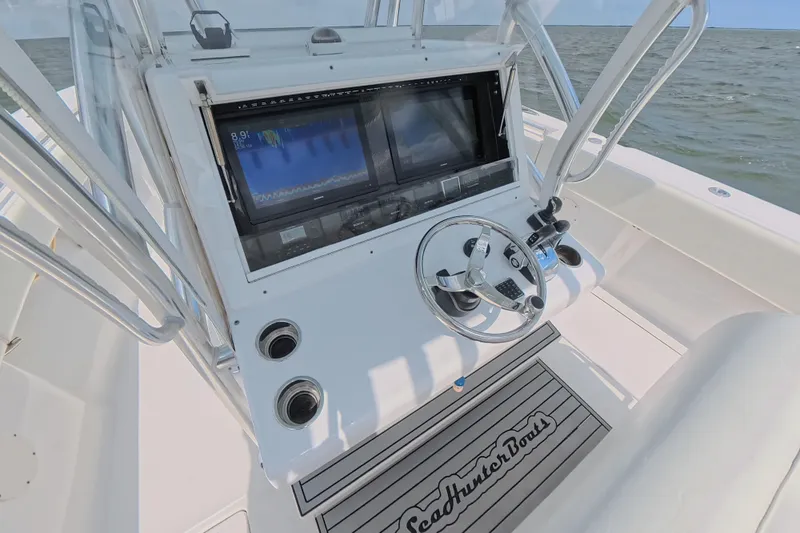  Yacht Photos Pics 2019 SeaHunter 33 Tournament boat console with steering wheel and navigation screens.