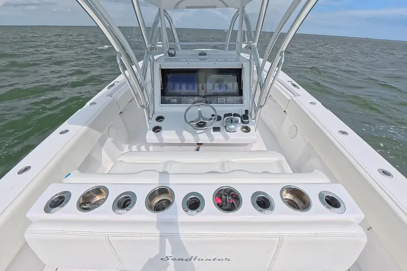  Yacht Photos Pics 2019 SeaHunter 33 Tournament boat cockpit with steering wheel and control panel on open water.