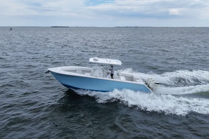  Yacht Photos Pics 2019 SeaHunter 33 Tournament boat cruising on open water under a cloudy sky.
