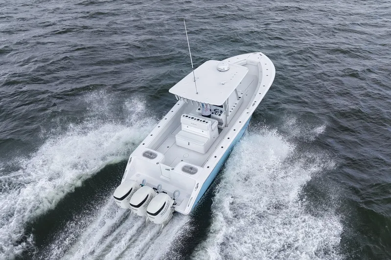  Yacht Photos Pics 2019 SeaHunter 33 Tournament boat cruising on open water, aerial view.
