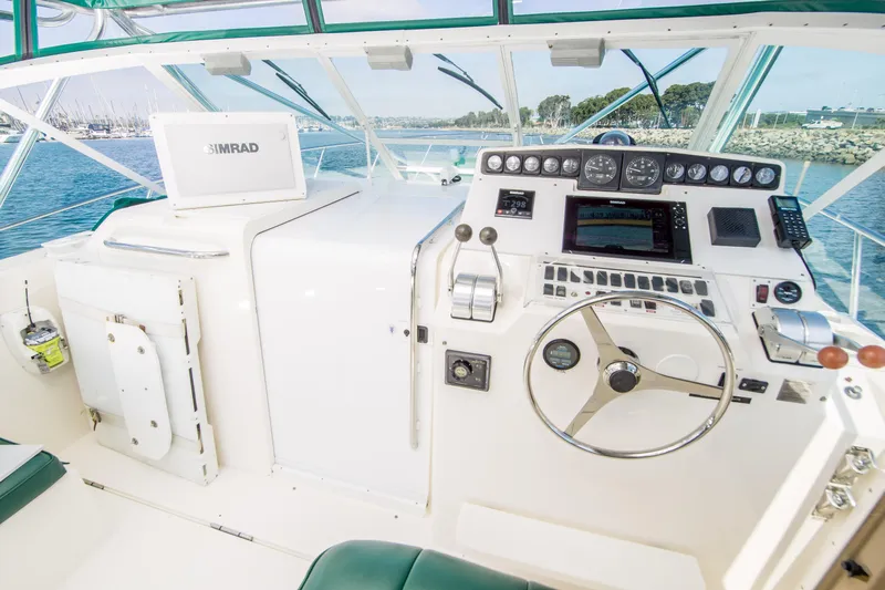 Dos Panchos Yacht Photos Pics 1997 Cabo 35 Express boat helm with navigation equipment and steering wheel.