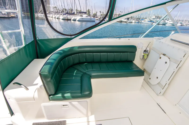 Dos Panchos Yacht Photos Pics 1997 Cabo 35 Express boat with green seating, docked at marina.