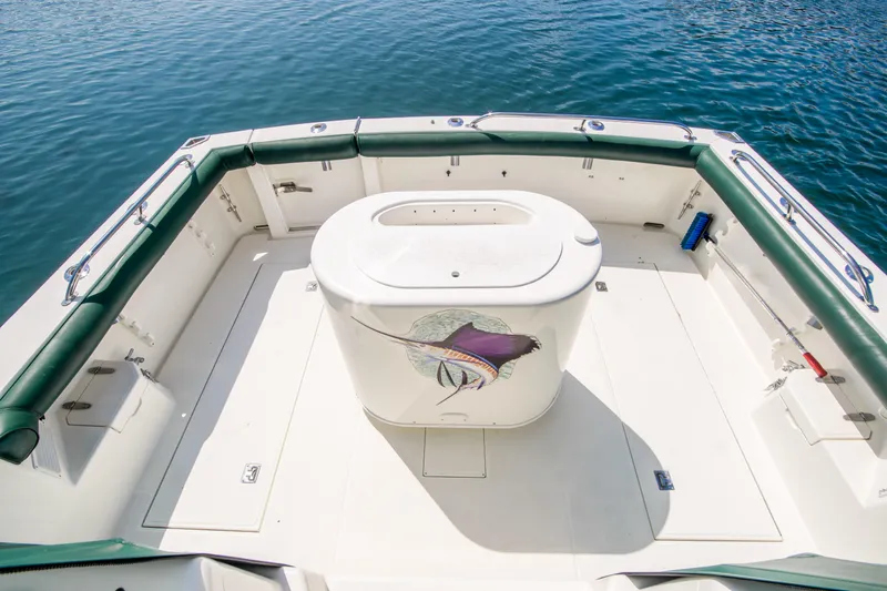 Dos Panchos Yacht Photos Pics 1997 Cabo 35 Express boat deck with central storage, surrounded by calm water.