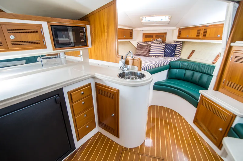 Dos Panchos Yacht Photos Pics Interior of 1997 Cabo 35 Express yacht with kitchenette and seating area.